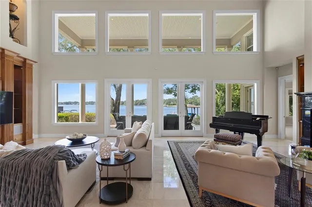 a dining room with furniture a large window and wooden floor