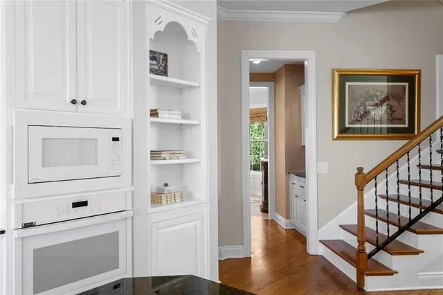 a kitchen with cabinets and white stainless steel appliances