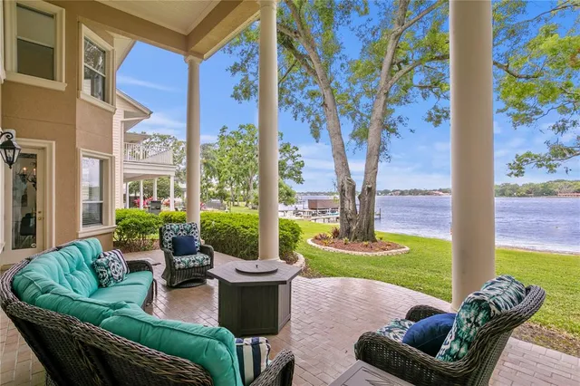 a view of a patio with couches chairs and a potted plants