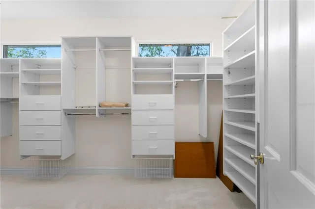 a view of a swimming pool with a table and chairs under an umbrella