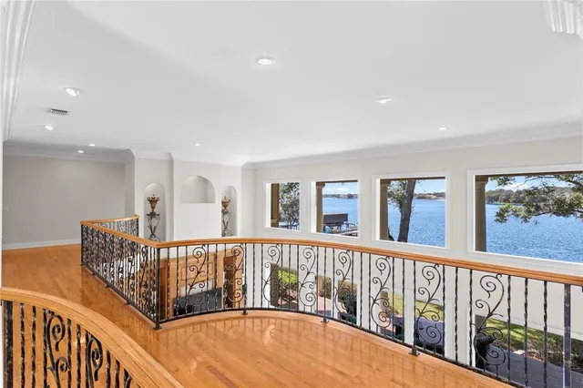an aerial view of a house with a garden and lake view
