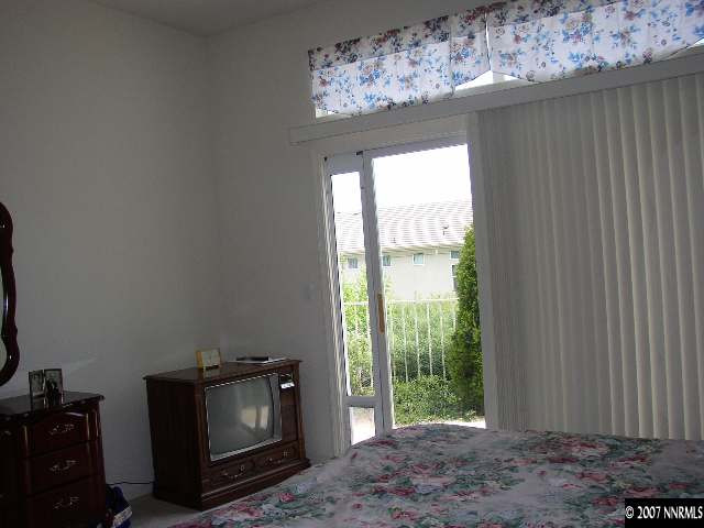 487 Sierra Leaf Circle Reno, NV 89511 - Photo 4 of 9 a view of an empty room with a fireplace and a window