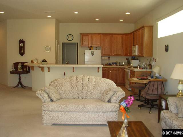 487 Sierra Leaf Circle Reno, NV 89511 - Photo 5 of 9 a living room with furniture kitchen area and a wooden floor