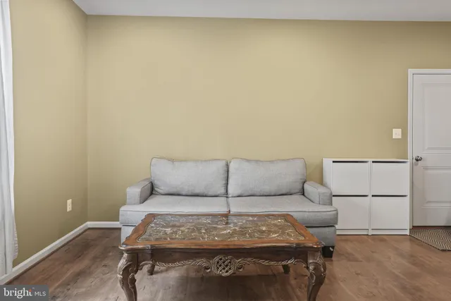 a living room with a couch and a white wall