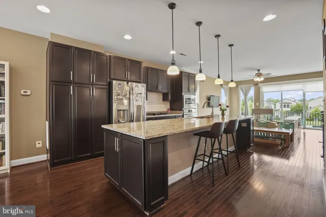 a kitchen with kitchen island a wooden floor and a window