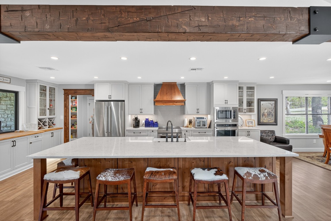 23642-23644 Nameless Road Leander, TX 78641 - Photo 24 of 37 a dining hall with stainless steel appliances a table and chairs