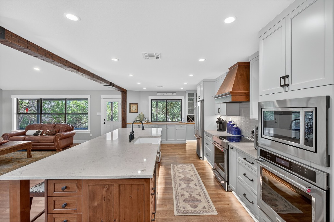 23642-23644 Nameless Road Leander, TX 78641 - Photo 26 of 37 a kitchen with stainless steel appliances a stove a sink a microwave a dining table and chairs