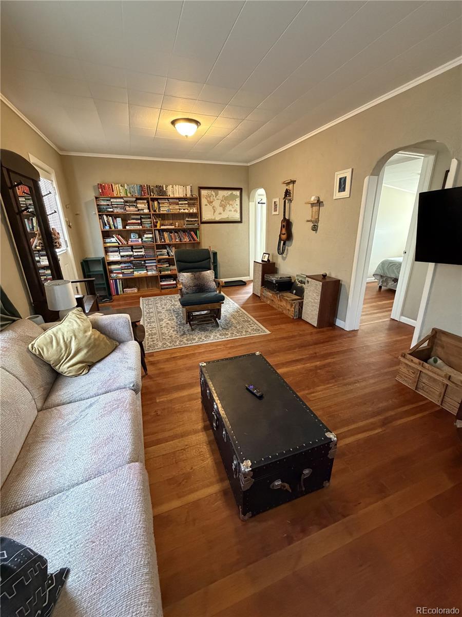 321 Jefferson Street Sterling, CO 80751 - Photo 3 of 10 a living room with furniture gym equipment and a flat screen tv