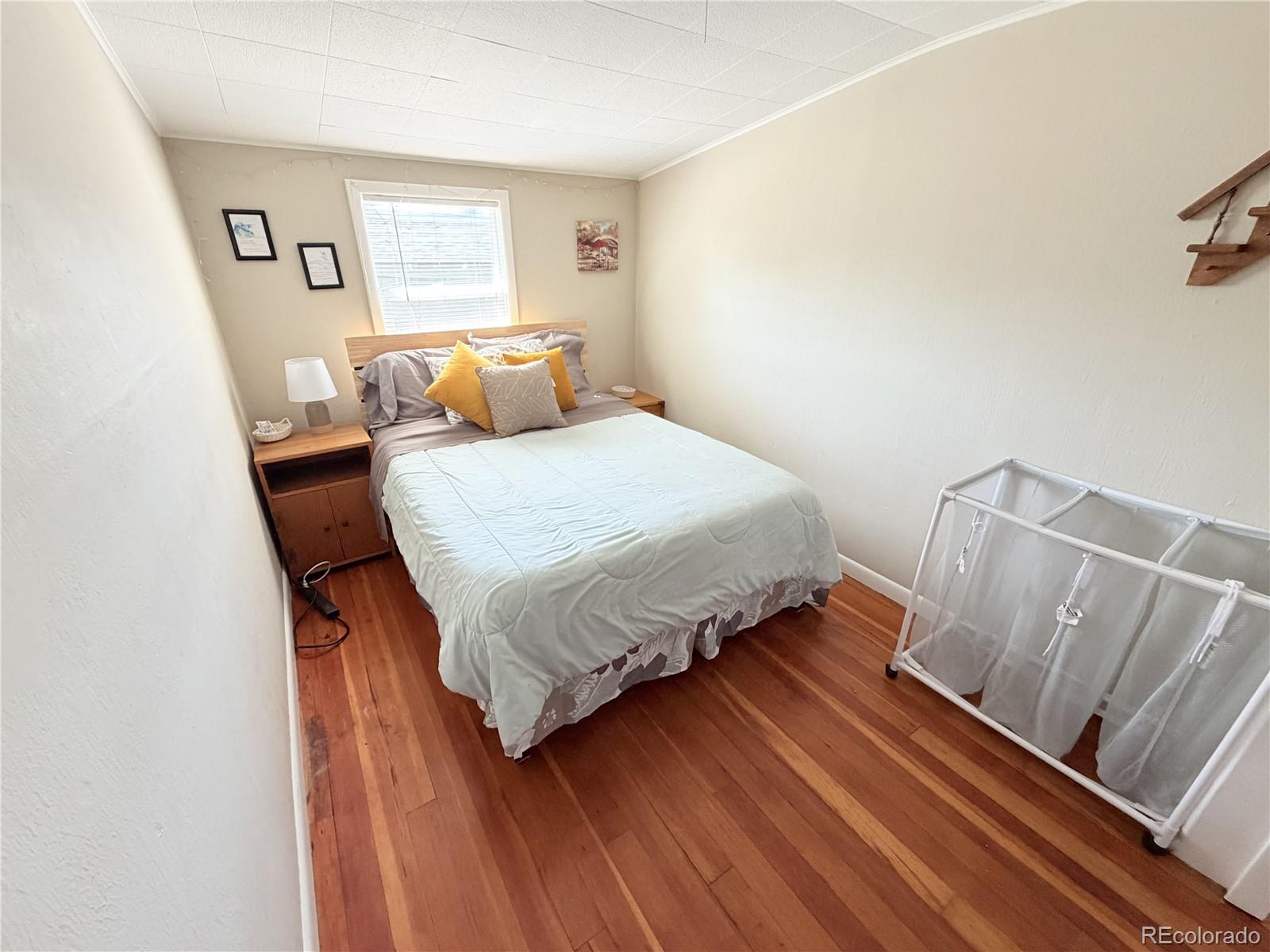 321 Jefferson Street Sterling, CO 80751 - Photo 5 of 10 a bedroom with a bed and window