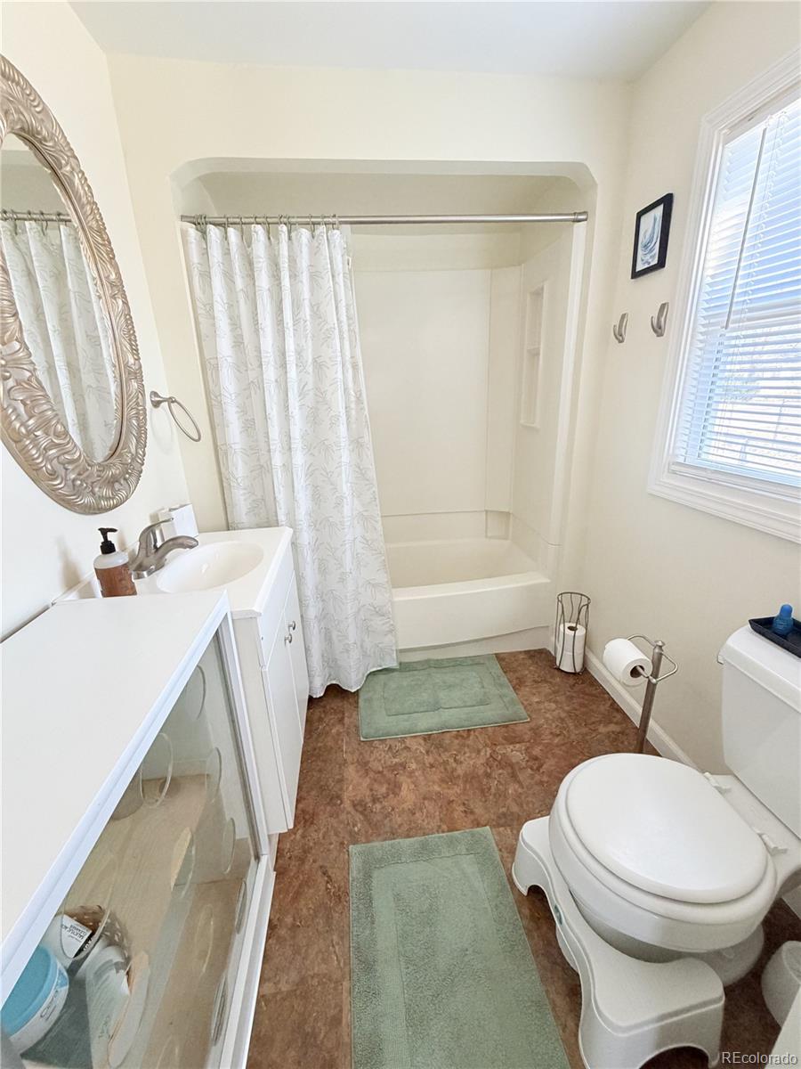 321 Jefferson Street Sterling, CO 80751 - Photo 7 of 10 a bathroom with a sink a toilet and a mirror