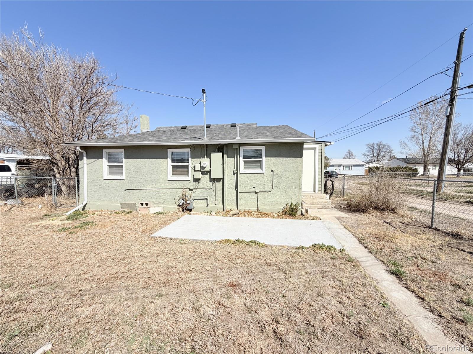 321 Jefferson Street Sterling, CO 80751 - Photo 9 of 10 a front view of a house with a yard