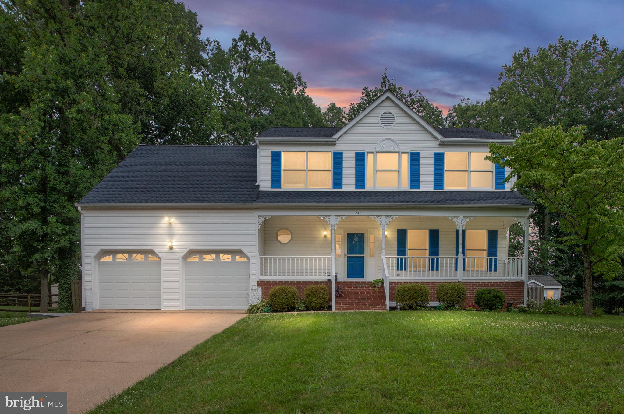 246 Choptank Road Stafford, VA 22556 - Photo 1 of 98 a front view of a house with a yard and garage