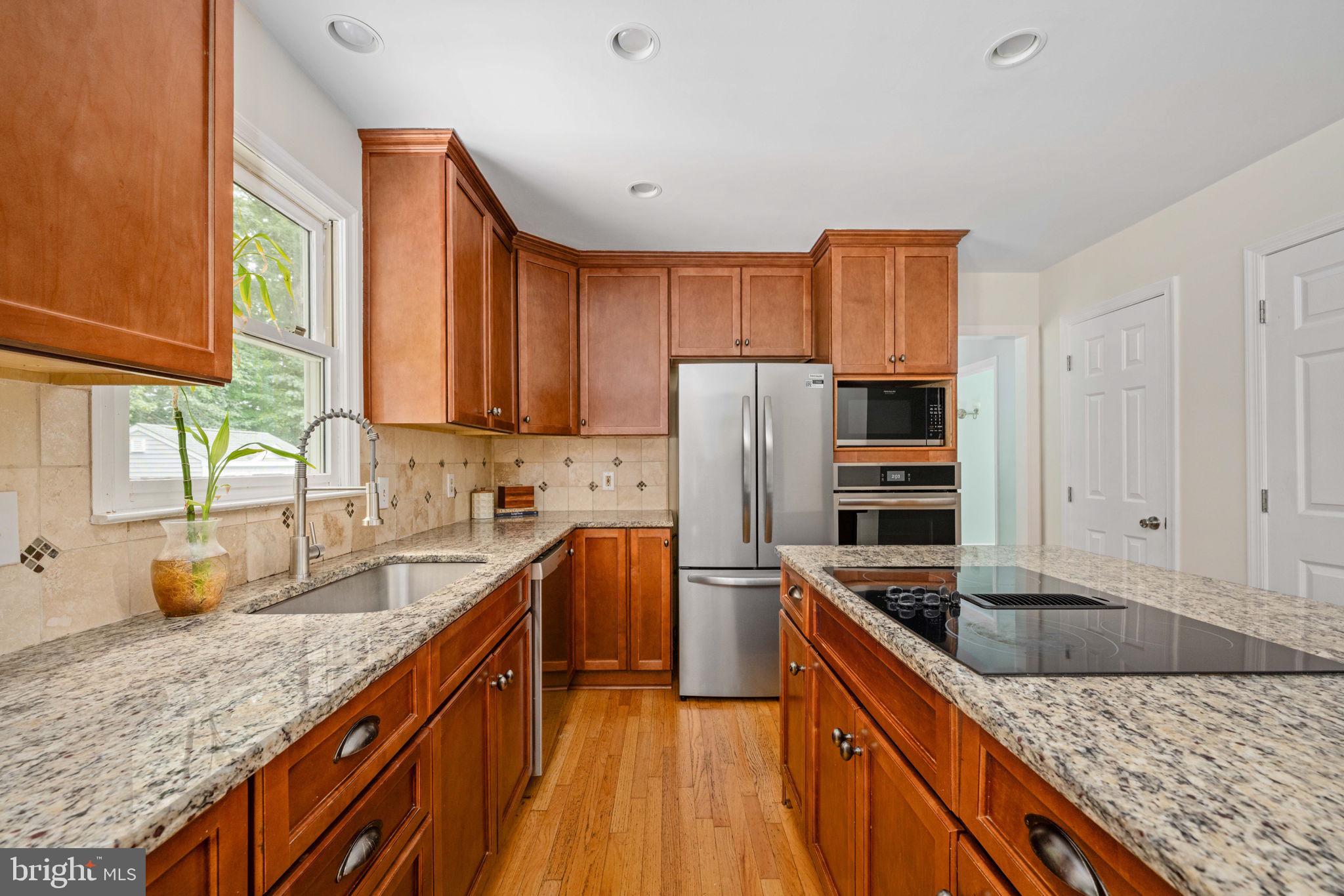 246 Choptank Road Stafford, VA 22556 - Photo 29 of 98 a kitchen with granite countertop a sink a counter space appliances and cabinets