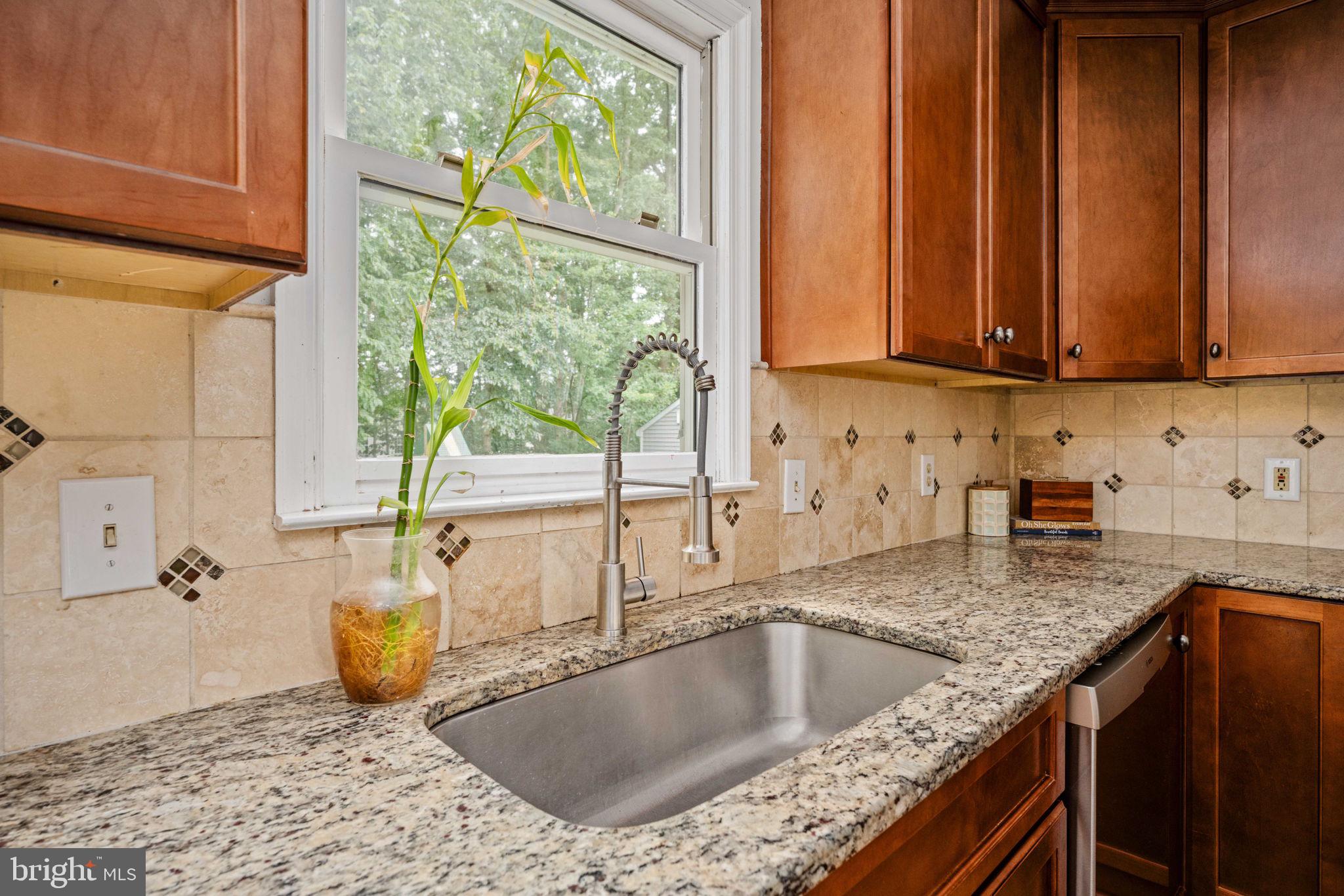 246 Choptank Road Stafford, VA 22556 - Photo 30 of 98 a kitchen with granite countertop a sink a counter top space and cabinets