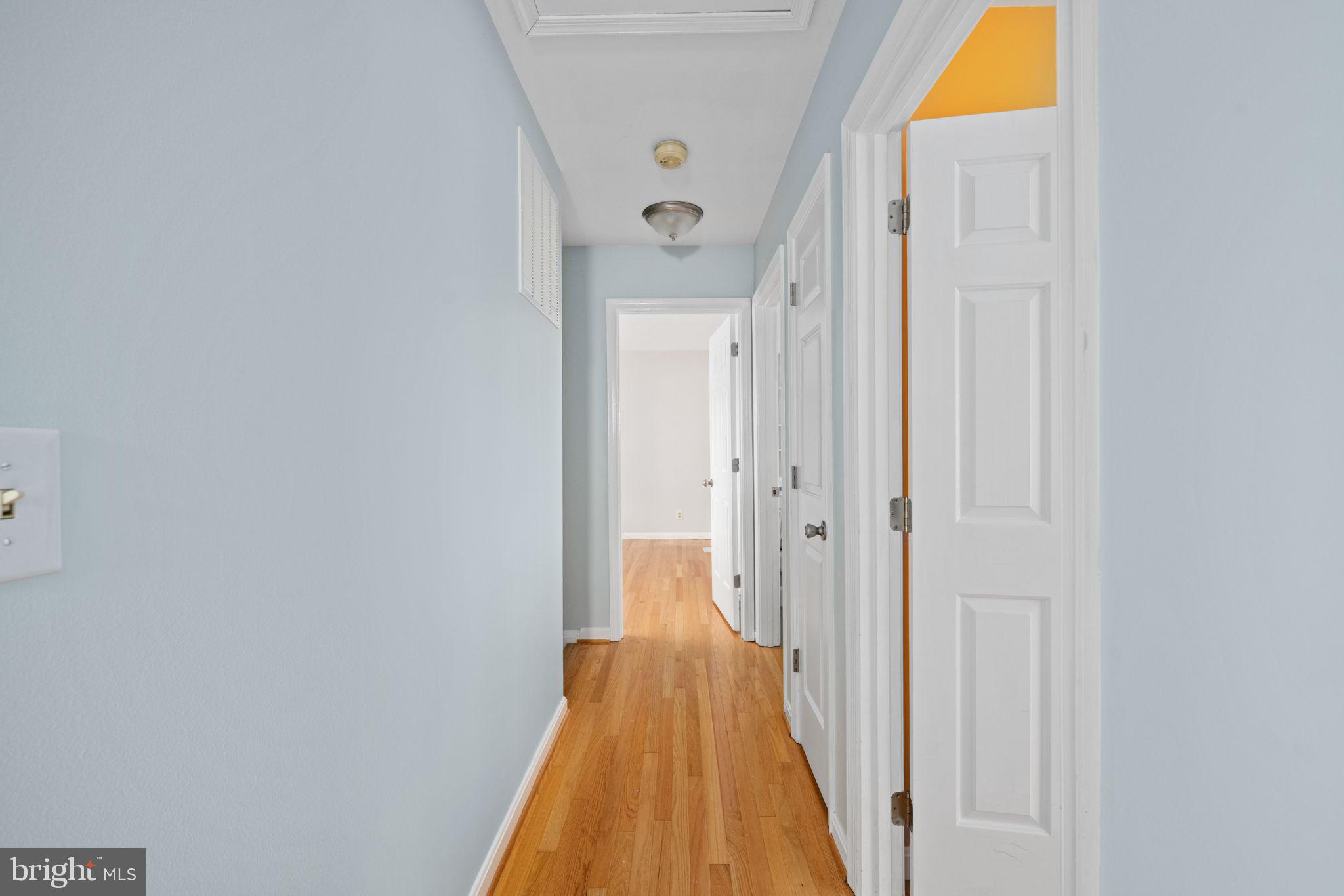 246 Choptank Road Stafford, VA 22556 - Photo 65 of 98 a view of a hallway with wooden floor and a bathroom