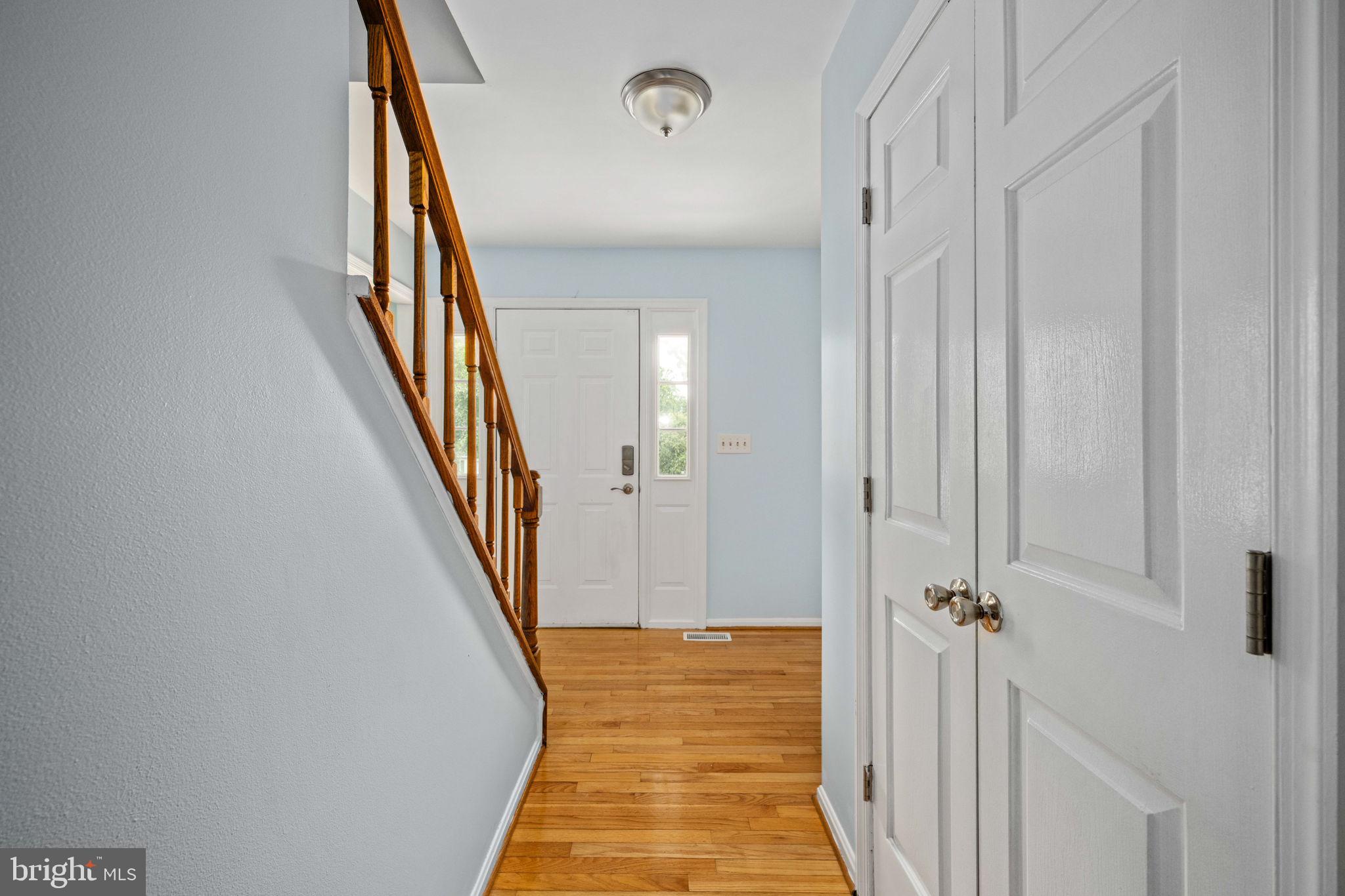 246 Choptank Road Stafford, VA 22556 - Photo 7 of 98 a view of a hallway with wooden floor and staircase