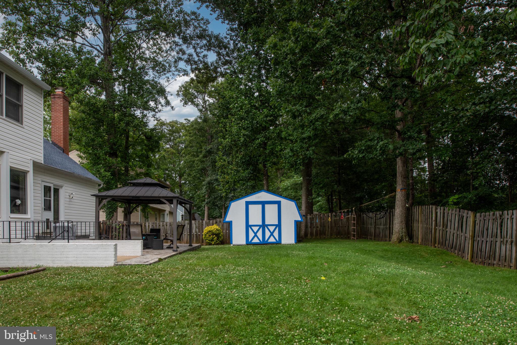 246 Choptank Road Stafford, VA 22556 - Photo 82 of 98 a view of a house with a yard and sitting area