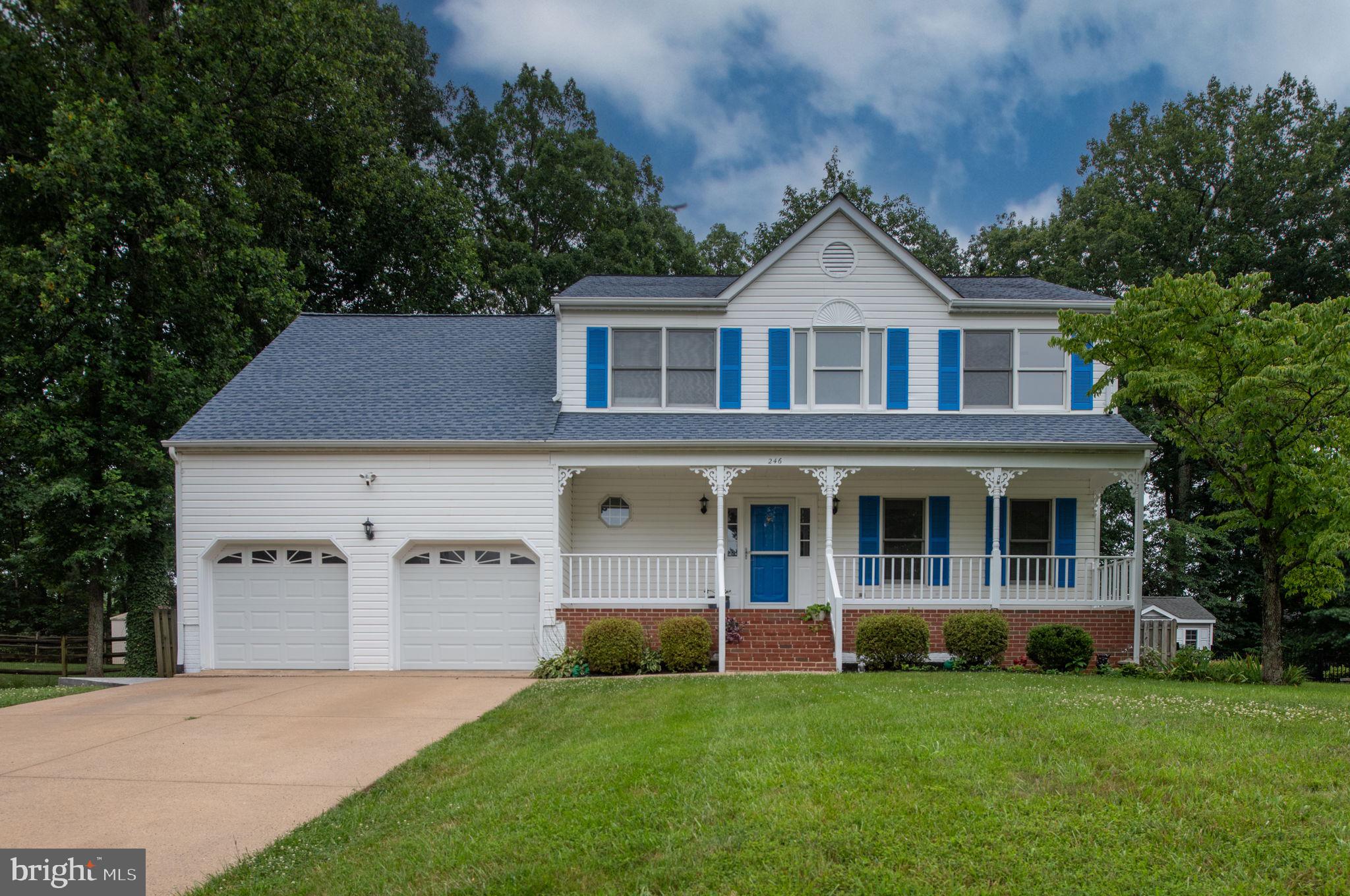 246 Choptank Road Stafford, VA 22556 - Photo 90 of 98 a front view of a house with a garden and yard