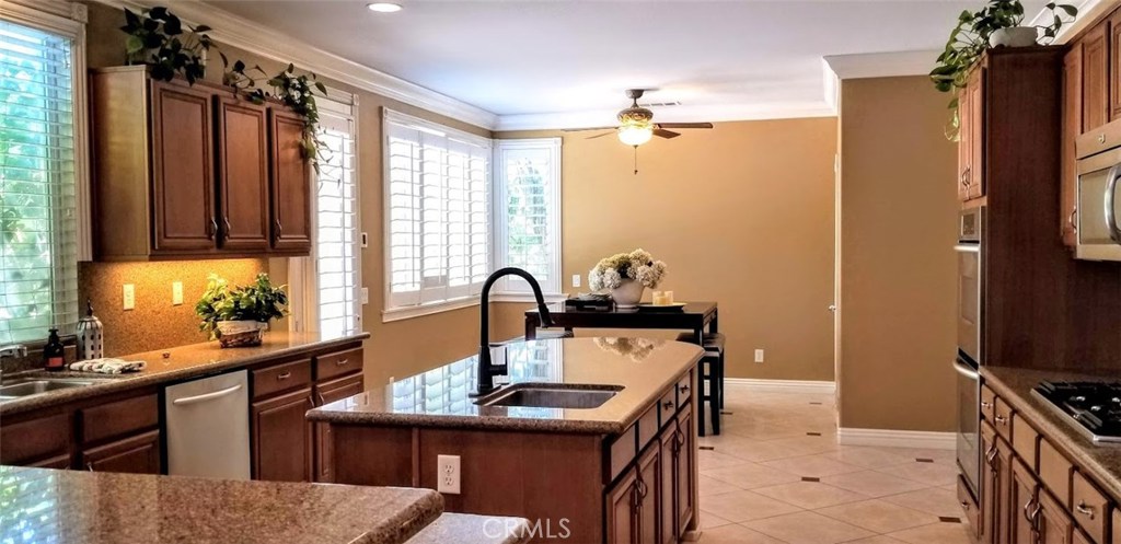 2394 Old Heritage Road Riverside, CA 92503 - Photo 23 of 45 a kitchen with kitchen island a sink stove and window