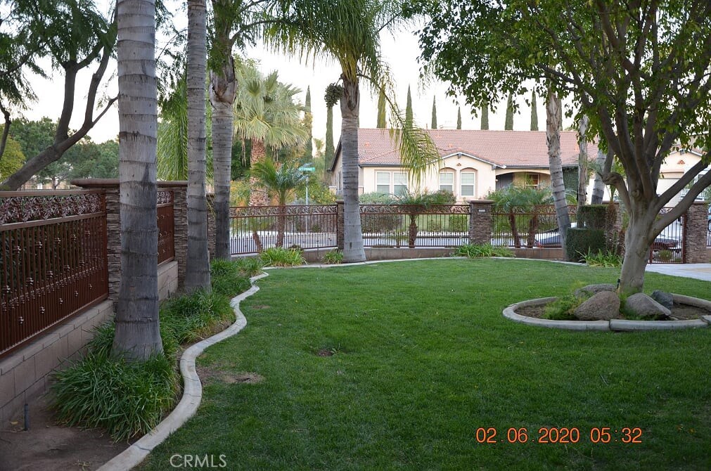 2394 Old Heritage Road Riverside, CA 92503 - Photo 45 of 45 a view of a fountain in front of a brick house with a large tree