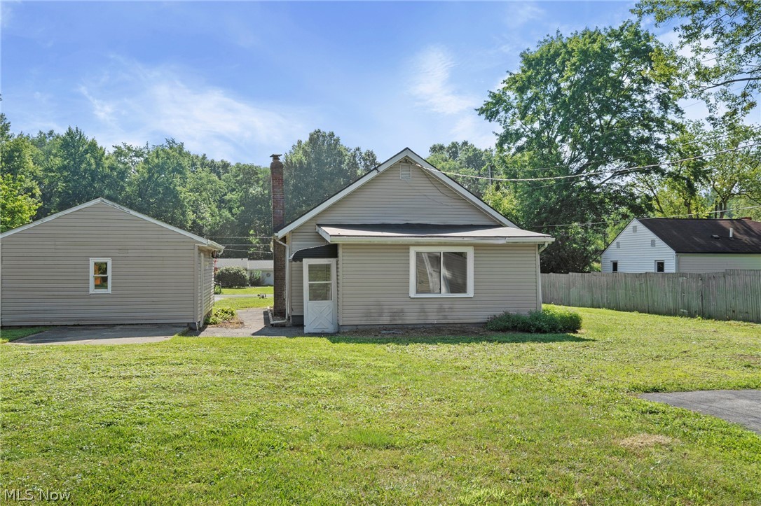 1218 Briggle Road Akron, OH 44320 - Photo 32 of 40 Rear exterior featuring siding, a screen door, and a brick chimney