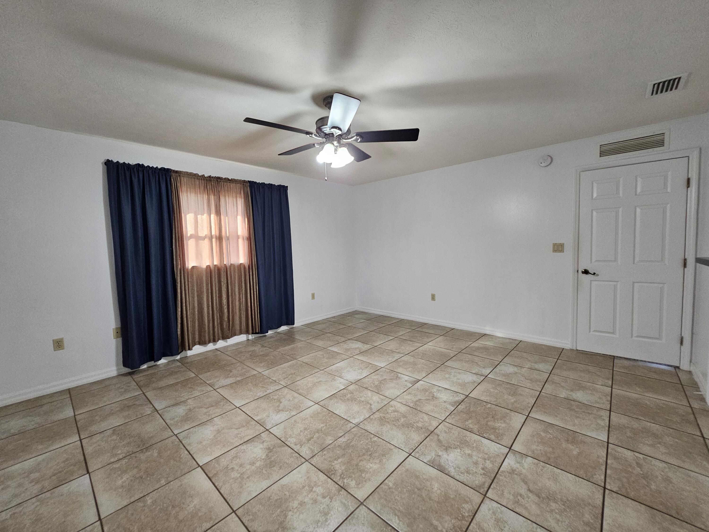1514 Summer Road Lake Placid, FL 33852 - Photo 22 of 52 a view of a livingroom with a ceiling fan and window