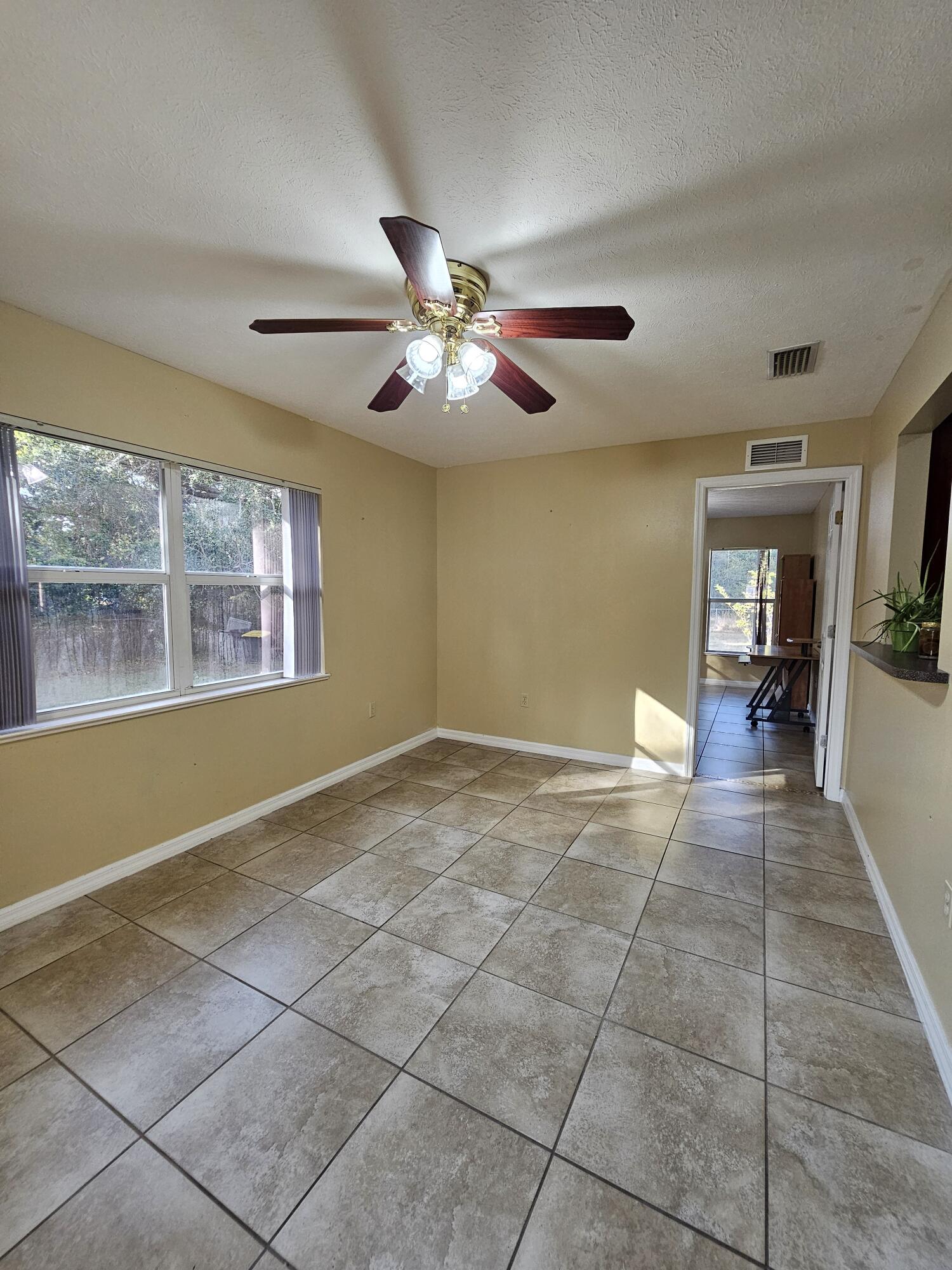 1514 Summer Road Lake Placid, FL 33852 - Photo 23 of 52 a view of an empty room with window and chandelier fan