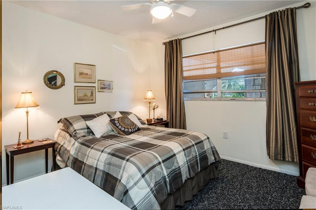 5451 Rattlesnake Hammock Road, Unit D108 Naples, FL 34113 - Photo 11 of 17 a bedroom with a bed and a window