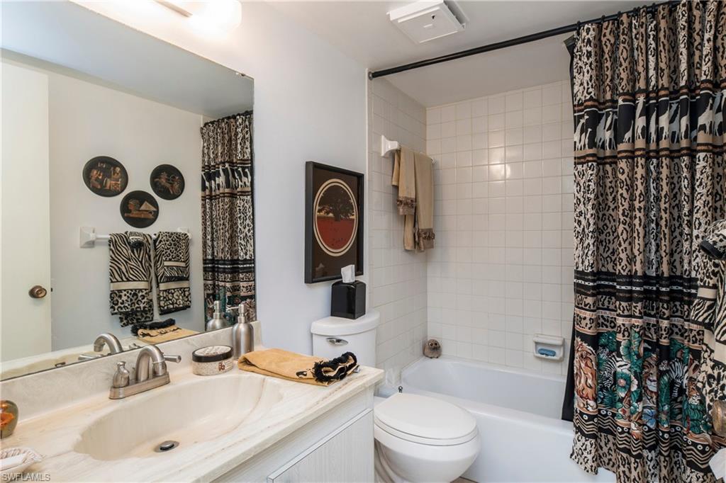 5451 Rattlesnake Hammock Road, Unit D108 Naples, FL 34113 - Photo 12 of 17 a bathroom with a sink toilet and shower