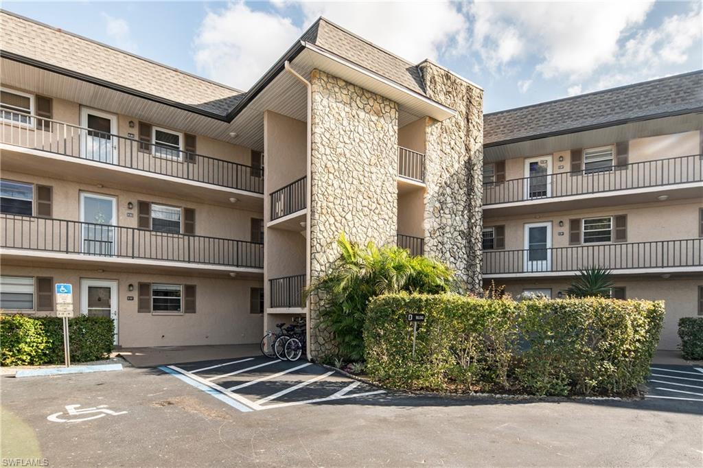 5451 Rattlesnake Hammock Road, Unit D108 Naples, FL 34113 - Photo 13 of 17 a view of a house with a garden