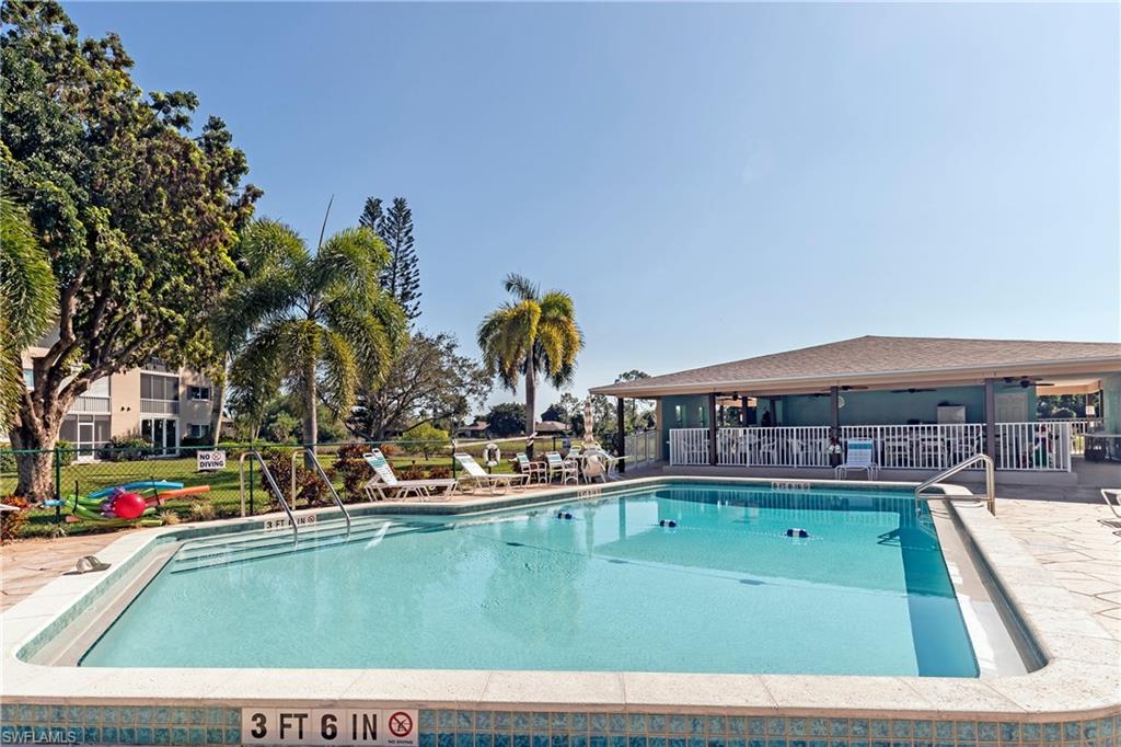 5451 Rattlesnake Hammock Road, Unit D108 Naples, FL 34113 - Photo 15 of 17 a view of swimming pool with outdoor seating