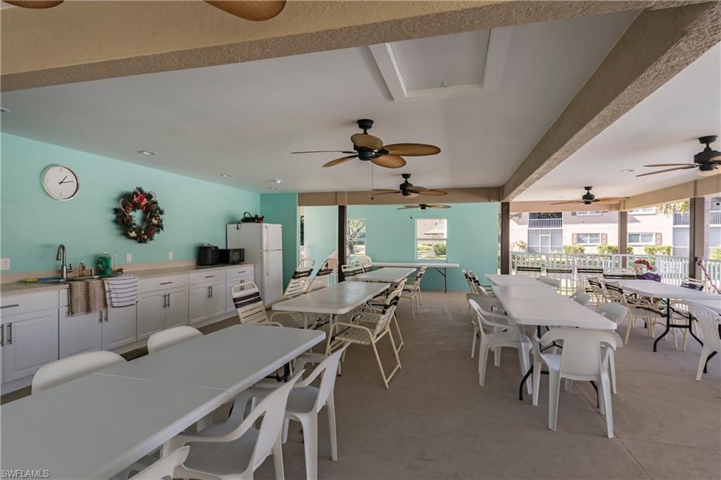 5451 Rattlesnake Hammock Road, Unit D108 Naples, FL 34113 - Photo 16 of 17 a view of a dining room with furniture and a large window
