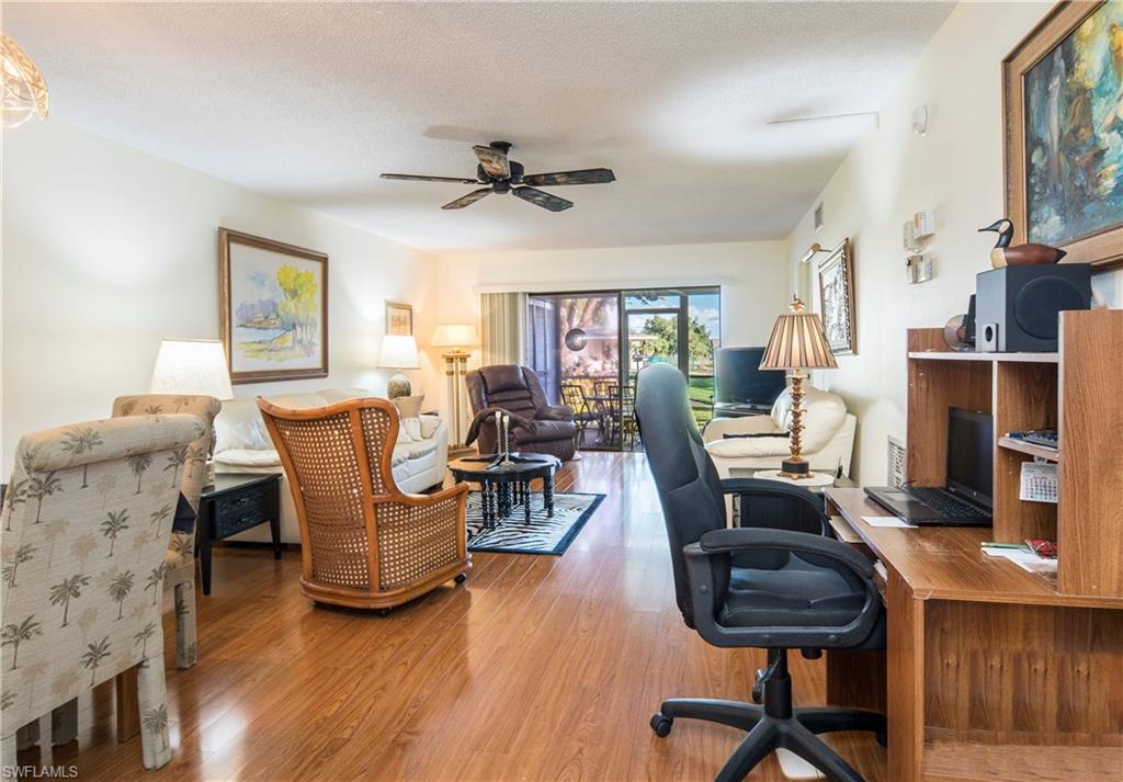5451 Rattlesnake Hammock Road, Unit D108 Naples, FL 34113 - Photo 7 of 17 a living room with furniture and a flat screen tv