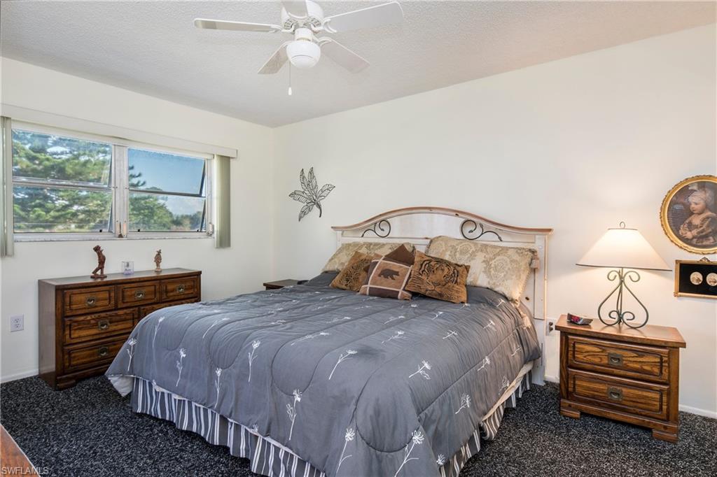 5451 Rattlesnake Hammock Road, Unit D108 Naples, FL 34113 - Photo 8 of 17 a bedroom with a bed and a dresser