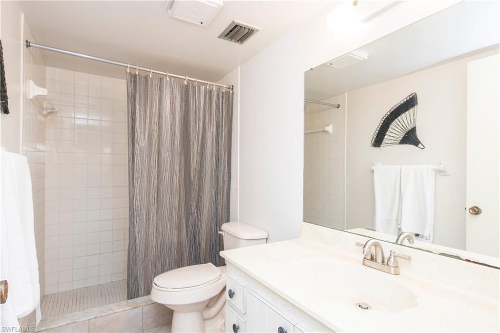 5451 Rattlesnake Hammock Road, Unit D108 Naples, FL 34113 - Photo 10 of 17 a bathroom with a sink toilet and shower