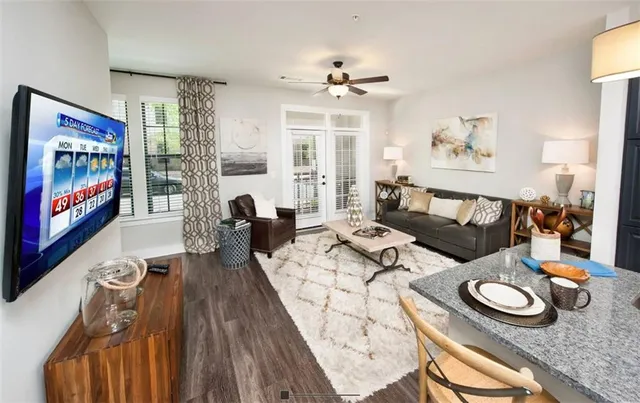 a living room with furniture and a flat screen tv