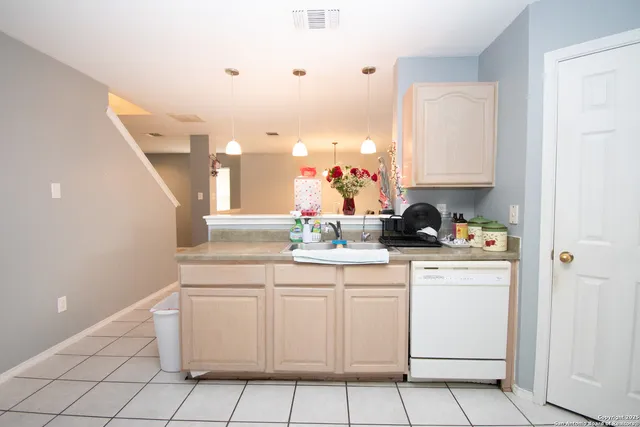 a kitchen with white cabinets