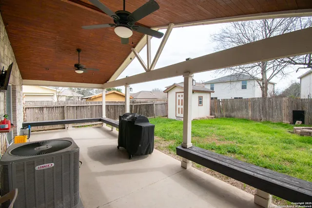 a view of a house with wooden fence