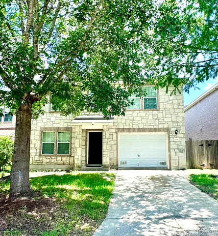 a view of a house with a yard and a garage