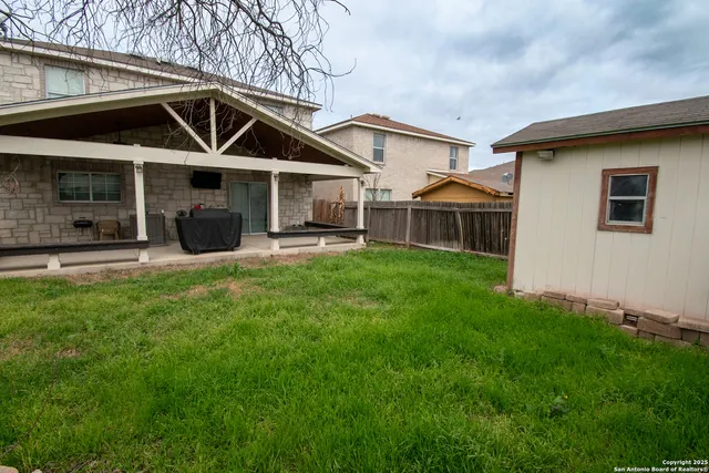 a front view of a house with a yard table and chairs