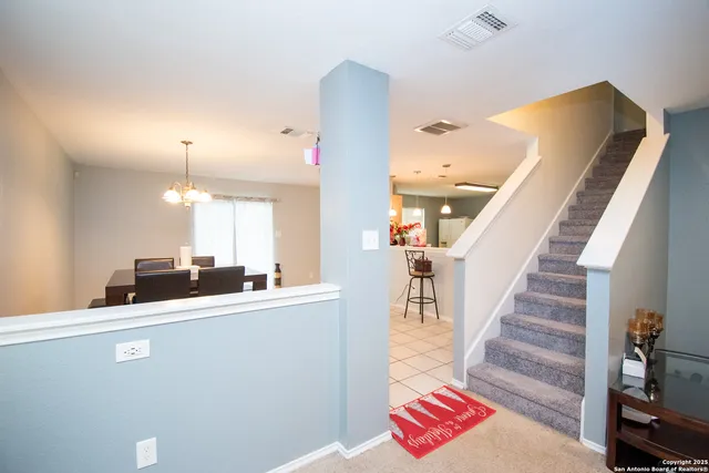 a view of a living room with furniture and a chandelier