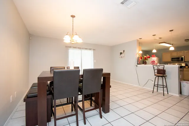 a view of a dining room with furniture and window