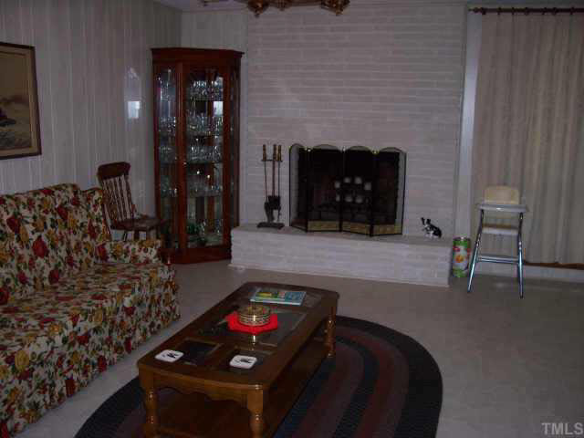 2109 East Charlotte Court Raleigh, NC 27607 - Photo 2 of 9 a living room with furniture and a fireplace