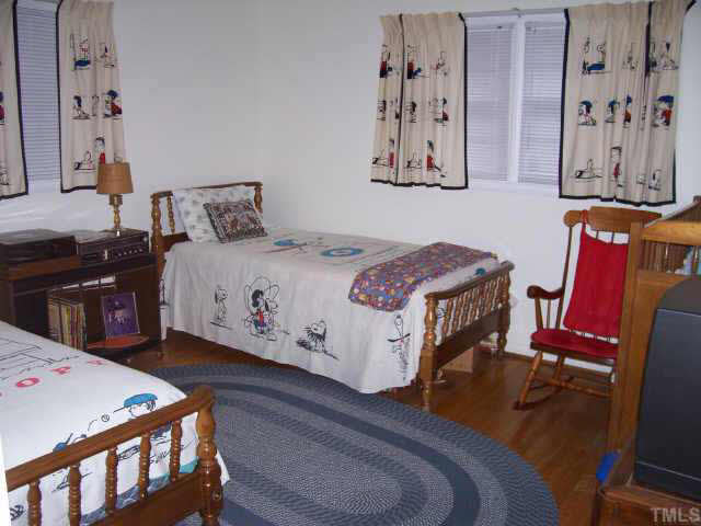 2109 East Charlotte Court Raleigh, NC 27607 - Photo 7 of 9 a bedroom with a bed and furniture
