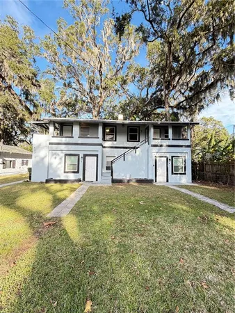 a front view of a house with yard and garage
