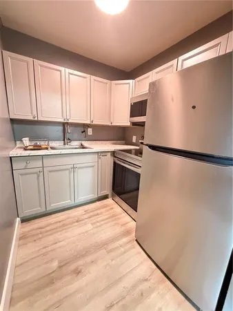 a kitchen with a refrigerator stove and microwave