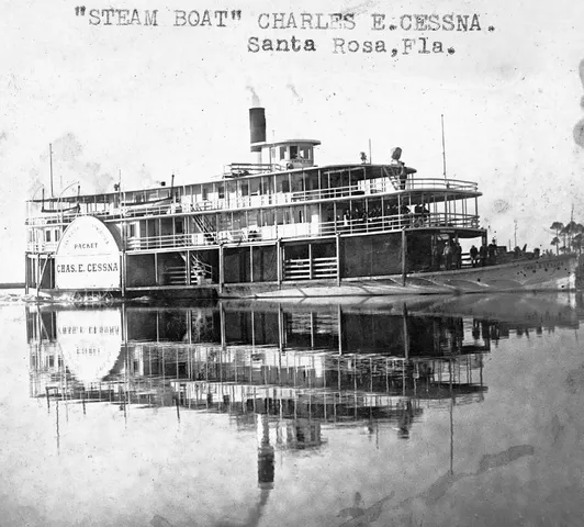 a front view of a building with glass top table and chairs