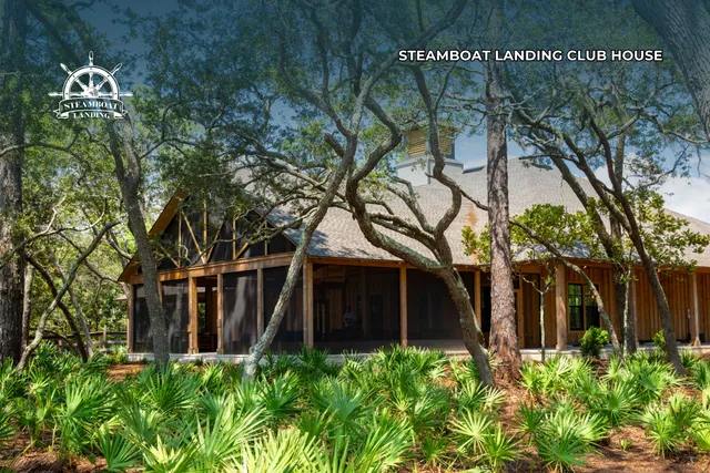 a front view of a house with plants and trees