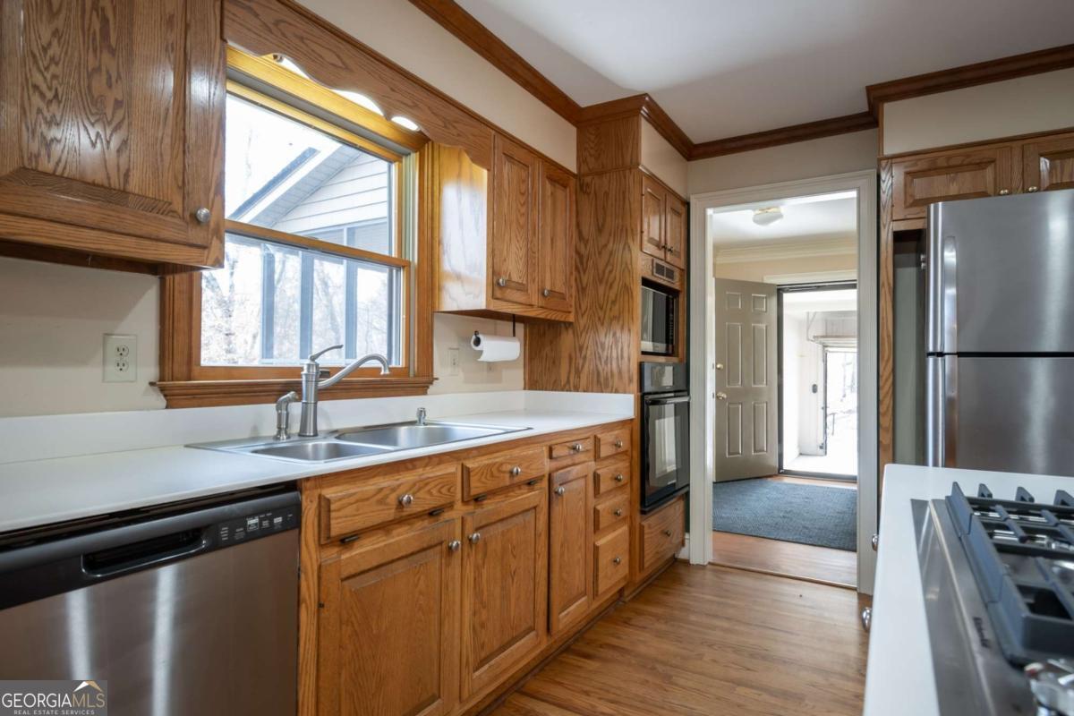 2191 Salem Road Watkinsville, GA 30677 - Photo 20 of 79 a kitchen with stainless steel appliances granite countertop a sink a stove and a refrigerator