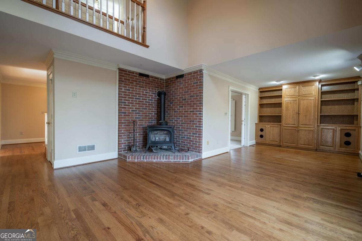 2191 Salem Road Watkinsville, GA 30677 - Photo 21 of 79 a view of a livingroom with wooden floor and a fireplace